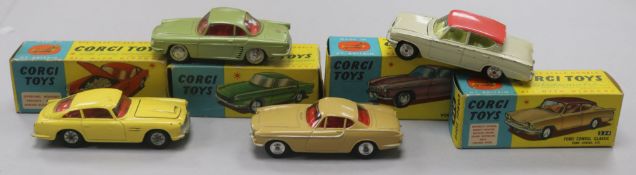 A Corgi Toys Aston Martin D.B.4 No. 218 and three other boxed Corgi cars, including Renault '