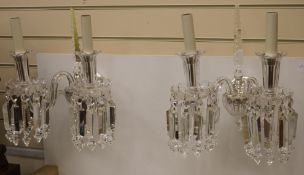 A pair of cut glass twin branch wall lights