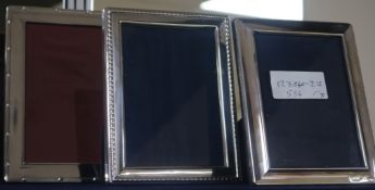 Three assorted modern silver photograph frames, largest 18.4cm.