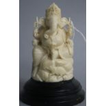 An Indian carved ivory figure of Ganesh, on ebonised socle