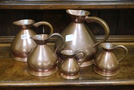 A graduated set of five 19th century French copper jugs