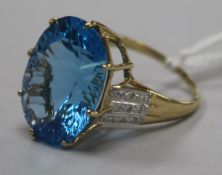 A 9ct gold and fancy cut blue topaz dress ring with diamond set shoulders, size Q.