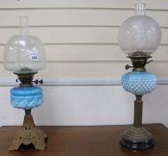 Two oil lamps with blue glass fonts