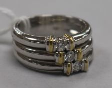 A modern 18ct white gold and diamond triple band ring, size O.