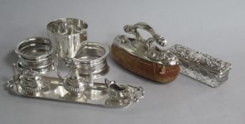 Three single napkin rings, a miniature three piece silver tea set and a tray, an American nail