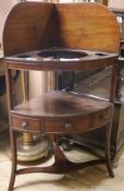 A George III mahogany bowfronted two tier corner washstand