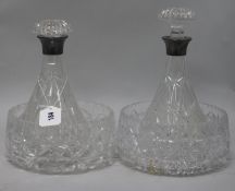 A pair of silver-mounted cut glass ship's decanters and two cut glass fruit bowls
