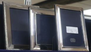 Three assorted 1990's silver mounted rectangular photograph frames, largest 23cm.