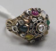 A gold and multi gem set dome topped dress ring, size P.