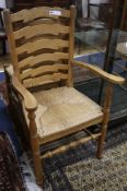 A set of eight early 20th century oak ladder back cottage dining chairs, with rush seats,