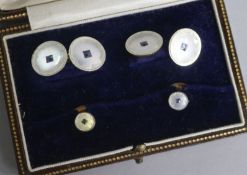 A early 20th century cased 18ct & 9ct gold, mother of pearl and gem set four piece dress stud set.