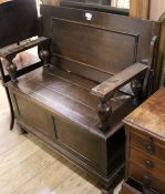 A 1930's oak monk's bench, W.107cm