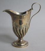 A Victorian demi-fluted silver helmet shaped cream jug by George Unite , Birmingham, 1896, 12cm.