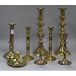 Three pairs of brass candlesticks, another and a candlestick holder