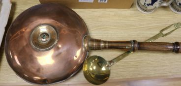 A Victorian copper warming pan and a brass ladle