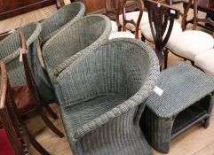 Four green 'Lloyd Loom' armchairs and a coffee table