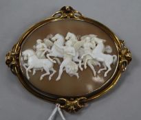 A Victorian gold mounted oval cameo brooch carved with figures and winged horses, 81mm.