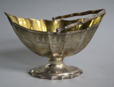 A George III silver bat's wing boat shaped sugar basket, with gilt interior, by Robert Hennell,