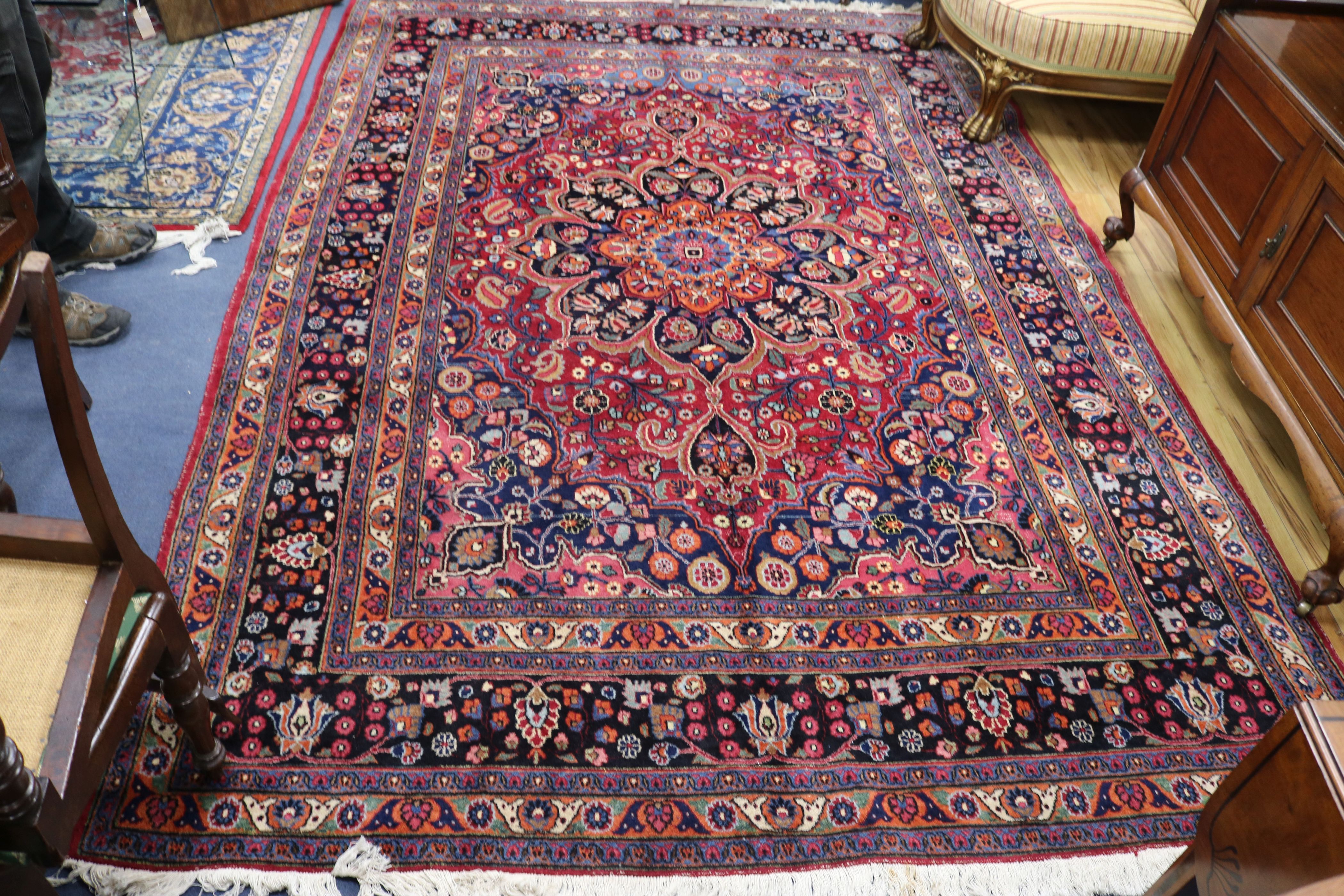 An antique Persian Mashad carpet, 309 x 124cm