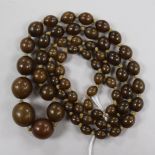 A single strand olive coloured bead necklace, gross 50 grams, 80cm.