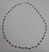 A 14ct gold and sapphire set spectacle necklace, 50cm.