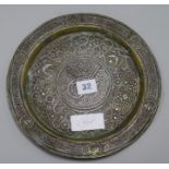 A Persian silver and brass dish