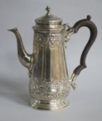 An Edwardian embossed silver cafe au lait pot by Charles Stuart Harris & Sons, London, 1905, gross