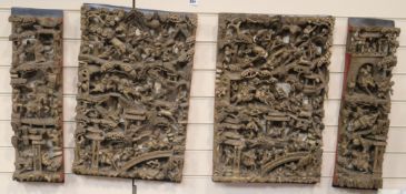 Four Chinese carved giltwood panels of battle scenes