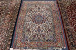 A Tabriz cream ground rug x 115cm.