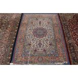 A Tabriz cream ground rug x 115cm.