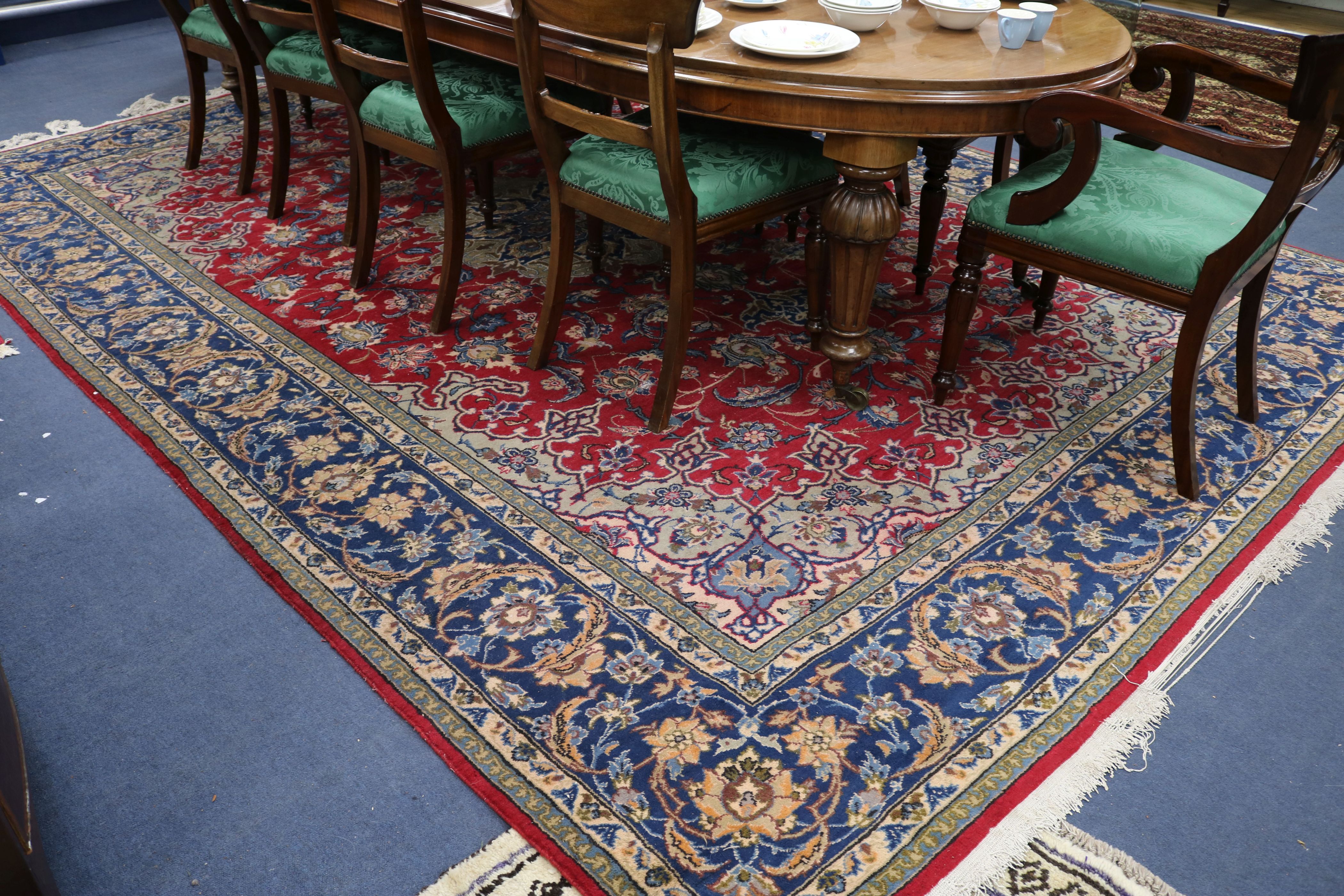 A red ground carpet 385 x 285cm