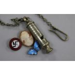 A Nazi badge, a silver enamel butterfly, a compass and a police whistle, etc