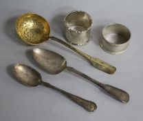 A late 18th/early 19th century French silver gilt sifter spoon, two later silver spoons and two