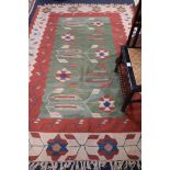 A Kelim rug 243 x 166cm and a pair of wool rugs