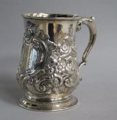 A late George II silver baluster mug with late embossed decoration and engraved inscription, William