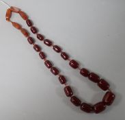 A single strand simulated cherry amber bead and five agate bead necklace, gross 112 grams, 62cm.