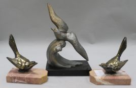 A pair of bird bookends and a bird ornament