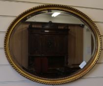 An oval gilt wall mirror W.66cm