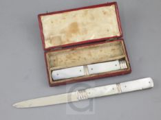 A cased Georgian silver and mother of pearl folding travelling fruit knife and fork, in fitted red