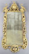 A George III Chippendale period giltwood wall mirror, with foliate scroll carved frame capped with