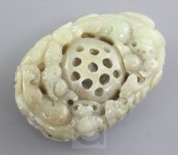 A Chinese celadon and brown jade carving, 20th century, carved as a lotus pod surrounded by two