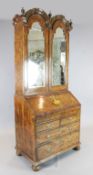 A George I and later walnut double dome bureau bookcase, with two mirrored doors enclosing a