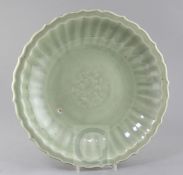 A Chinese Longquan celadon dish, Ming dynasty, c.1400, the centre moulded with a lotus flower and