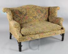 A George III mahogany settee, of wingback form with blind fret carved squared legs, W.5ft6in. D.