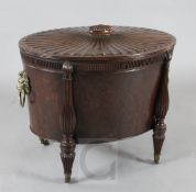 A Regency mahogany cellarette, of oval form, with starburst fluted top, fluted baluster pilasters