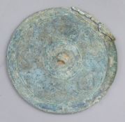 A Chinese bronze circular mirror, Eastern Zhou dynasty, 4th-3rd century B.C. cast in low relief with