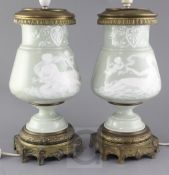 A pair of Paris porcelain pate-sur-pate celadon ground and ormolu mounted lamp bases, late 19th
