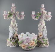 A pair of German floral encrusted porcelain three branch candelabra and a matching monteith, late