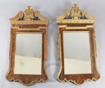 A pair of mid 18th century style carved giltwood and walnut wall mirrors, of architectural form with