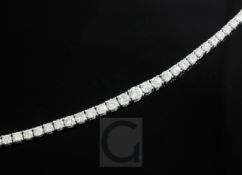 A modern 18ct white gold and diamond line bracelet, set with forty nine graduated round brilliant